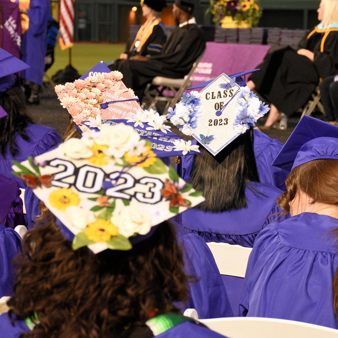 image of students with decorated mortarboard