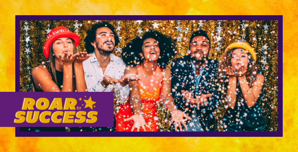 A event image that is titled Roar to Success. A group of people in celebration, blowing glitter. 