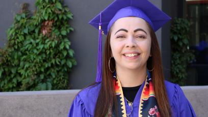 Michelle Solano poses in her graduation regalia