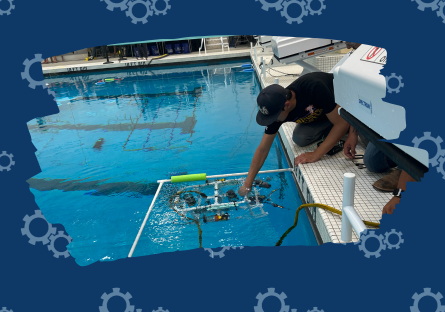 Team member with the ROV in the water