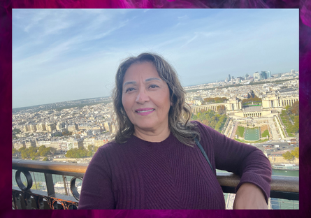 Student, Estela Munoz, posing with a cityscape background.