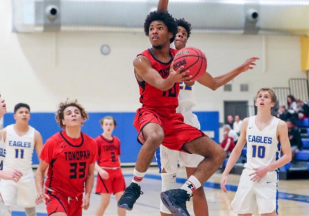 Photo of Cameron Gates and other males playing basketball