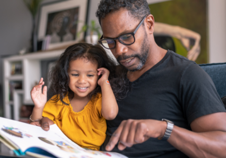 Father and daughter reading a book