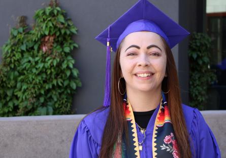 Michelle Solano poses in her graduation regalia