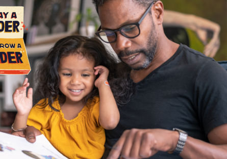 Father and daughter reading a book