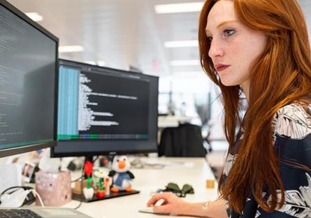 women coding on a computer