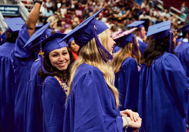 student looking behind her at graduation