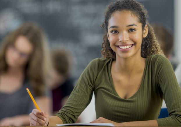 A young student looks at the camera while in class