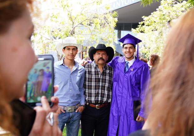 graduate with his family after the ceremony