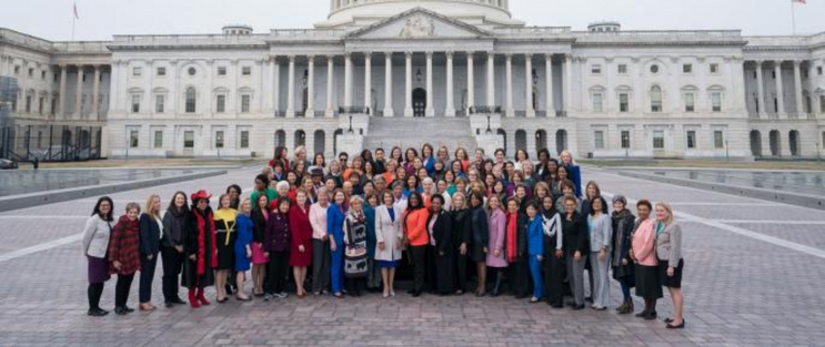 Women in Congress in front of a government building